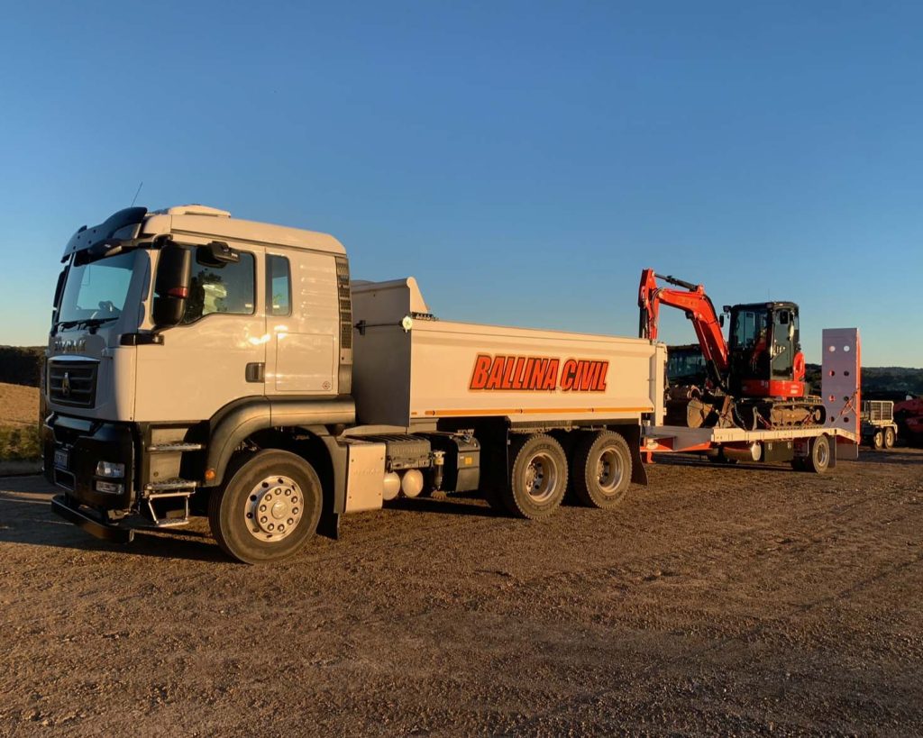 tipper truck with digger on trailer. Owned and operated by Ballina Tippers, part of the Ballina civil group, based in Ballina, Northern Rivers, NSW